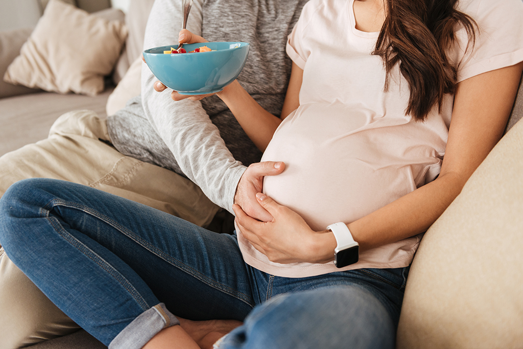 cropped photo of caucasian man touching pregnant PWUEBYJ